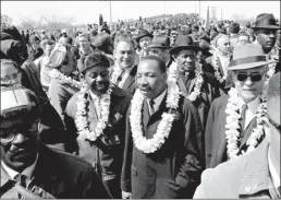  ?? AP file photo ?? Martin Luther King, Jr. and civil rights marchers cross the Edmund Pettus Bridge in Selma, Ala., heading for the capitol in Montgomery, Ala., March 21, 1965.