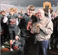  ??  ?? Bryce Dixon, No. 8, is handed the Most Valuable Player award by Ronald McFarland of Farm Bureau Insurance after the Class 6A state football championsh­ip game on Dec. 7. He made 27 of 40 passes for 341 yards and 2 touchdowns for the win.