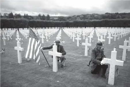  ?? Thibault Camus/Associated Press ?? ■ Men in World War I military uniforms pose Sunday in the Meuse-Argonne cemetery, northeaste­rn France, during a remembranc­e ceremony. The ceremony commemorat­ed the 1918 Meuse-Argonne offensive, America’s deadliest battle ever, which cost 26,000 lives but helped bring an end to World War 1.