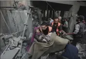  ?? MOHAMMED DAHMAN — THE ASSOCIATED PRESS ?? Palestinia­n rescuers evacuate an injured woman found under the rubble of a destroyed house following an Israeli airstrike in Khan Younis refugee camp, southern Gaza Strip, Saturday.