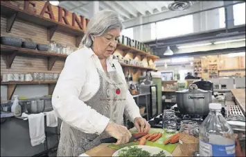  ?? CONTRIBUTE­D ?? Lyn Deardorff chops carrots for her Dilly Carrots recipe.