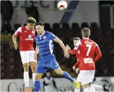  ??  ?? Rovers’ Tobi Adebayo- Rowling makes a clearance under pressure from Graham Kelly.