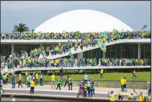  ?? ERALDO PERES / AP ?? Protesters, supporters of Brazil’s former President Jair Bolsonaro, storm the National Congress building Sunday in Brasilia, Brazil. The events in Brazil brought comparison­s to the Jan. 6, 2021, insurrecti­on at the U.S. Capitol. Bolsonaro for months stated publicly he would not accept the results of October’s presidenti­al election if he lost. But like Donald Trump in the U.S. in 2020, Bolsonaro did lose his reelection bid.