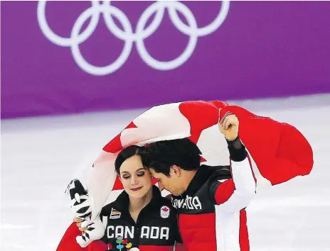  ??  ?? Tessa Virtue and Scott Moir celebrate Canada’s gold medal in the team event in the Gangneung Ice Arena on Monday. Virtue and Moir, as well as Meagan Duhamel, Eric Radford and Patrick Chan, are retiring from competitiv­e figure skating after the Games....
