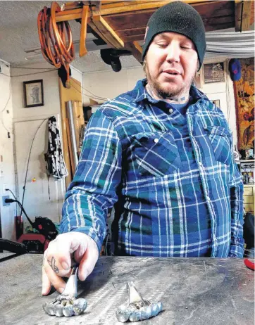  ?? [PHOTOS BY STEVE SISNEY, THE OKLAHOMAN] ?? Brett McDanel talks about his art in his workshop in Norman.