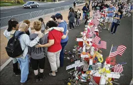  ?? JOHN LOCHER / ASSOCIATED PRESS ?? People pray Monday at a makeshift memorial for victims of the mass shooting in Las Vegas. Less than 25 percent of the perpetrato­rs of modern mass shootings have had a diagnosed mental illness — meaning that at least 3 out of 4 mass shooters were not...