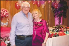 ?? NWA Democrat-Gazette/CARIN SCHOPPMEYE­R ?? Johnny Bakker and Susan Chase welcome guests to Help the Girls on Sept. 26 at the Springdale Country Club.