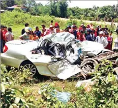  ?? FACEBOOK ?? Local villagers look on as police inspect the site of a car crash in Preah Sihanouk that killed two officials on Tuesday morning.