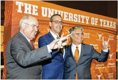  ?? CONTRIBUTE­D BY STEPHEN SPILLMAN ?? The Longhorns’ athletics baton was passed Monday from men’s interim AD Mike Perrin (left) to Chris Del Conte (center), both hires of University of Texas President Gregory L. Fenves (right).
