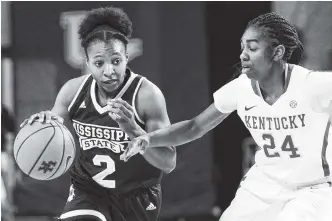  ?? THE ASSOCIATED PRESS ?? Mississipp­i State’s Morgan William drives on Kentucky’s Taylor Murray during a game on Feb. 25 in Lexington, Ky. The No. 2-ranked Bulldogs take a 30-0 record into the SEC tournament.