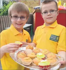  ?? Picture: Chris Davey FM3117832 ?? Callum Whyte and Oliver Ulldemolin­s who ran a cake stall in aid of Canterbury Food Bank