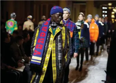  ?? Valerio Mezzanotti / The New York Times ?? Models on parade at the Versace menswear show in Milan on Jan. 13. For fall 2018, Neil Barrett honed his classic style while Versace ranged from zebra stripes to velvet suiting.