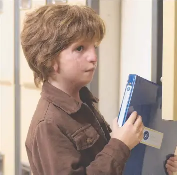  ??  ?? HEARTFELT STORY: Jacob Tremblay stars as Auggie, a boy with a genetic disorder, in Wonder, alongside Julia Roberts (top right); and (right) Auggie in the helmet he wears to hide his face.