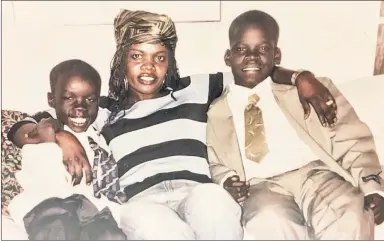  ?? Anthony J. Causi; Family photo ?? THE LONG ROAD: Nets rookie forward Nuni Omot was born in a Kenyan refugee camp after his family escaped civil war in Ethiopia. Omot (left) moved with his mother, Pillow, and his older brother, Aba (right) when he was 2 and, after stops at three colleges, is tr ying to make it in Brooklyn.