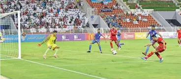  ?? (V K Shafeer/Muscat Daily) ?? Oman’s Ali al Busaidi (right) shoots but his effort is saved by Indian goalie Gurpreet Singh Sandhu at the SQSC on Tuesday