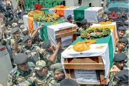  ?? –PTI ?? BSF men carry the bodies of four jawns killed in Pakistani firing at the border after a wreath-laying ceremony at Paloura BSF Headquarte­rs in Jammu on Wednesday.