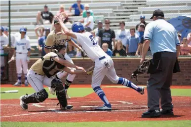  ?? Staff photo by Evan Lewis ?? Pleasant Grove catcher Keaton Russo makes a tag on Decatur’s Derek Potts to keep the Eagles scoreless in the eighth inning of Game 2 in Thursday’s regional final at Mike Carter Field in Tyler. The Hawks beat Decatur, 1-0, to advance to the state...