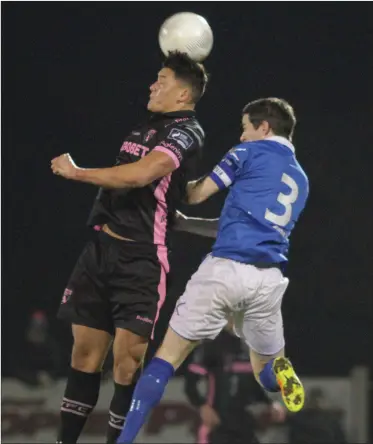  ??  ?? Wexford Youths midfielder Lee Chin wins this duel in the air with Finn Harps captain Ciarán Coll.