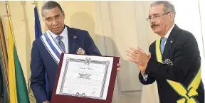  ?? RUDOLPH BROWN/PHOTOGRAPH­ER ?? Jamaicans may be quick to criticise Trump’s characteri­sation of Haiti as a “sh**hole” country, but Jamaican Prime Minister Andrew Holness took flak for endowing Dominican Republic President Danilo Medina Sanchez with the nation’s second-highest honour...