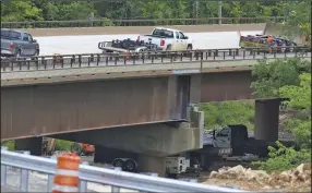  ?? (NWA Democrat-Gazette/Charlie Kaijo) ?? Vehicles cross the span Thursday that’s replacing the old Pruitt bridge. The new bridge, which opened May 14, is 327 feet longer than the old span and 45 feet wide, compared with the old span’s 20-foot width.