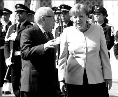  ??  ?? Essebsi (left) and Merkel speak as they review the honour guard upon her arrival in Tunis. — AFP photo