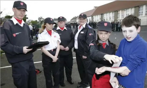  ??  ?? RIGHT: Lt Mick O’Keefe marks Shankill cadet Annalivia Hayes as she give first aid to Mikey Hayes, watched by Cpl Claire Wright, Cadet Leader Bray Unit; Cmdt Jeanette Wright, Regional Director; and Adjt Rachael Sheeran, Officer in Charge Shankill.