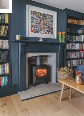  ??  ?? SITTING ROOM
An internal window brings more natural light into the cosy family space, which is centred around a woodburnin­g stove (below). Walls in Railings estate emulsion, £46.50 for 2.5ltr, Farrow & Ball. Aissa sofa, £1,460, Sofa.com