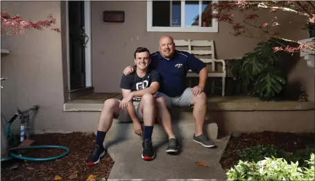  ?? NHAT V. MEYER — STAFF PHOTOGRAPH­ER ?? Cameron Hewitson, 17, and his father, Matt, principal of Abraham Lincoln High School, at their home in San Jose on Thursday. Cameron is a senior at the school.