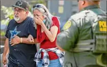  ?? William Luther / The San Antonio Express-news ?? A woman cries Tuesday as she leaves the Uvalde Civic Center. At least 19 students and two adults were shot and killed at Robb Elementary School in Uvalde, Texas.