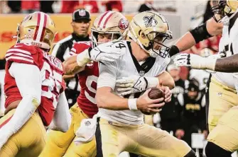  ?? Stephen Lam / The Chronicle ?? Saints quarterbac­k Andy Dalton is sacked for a 7-yard loss by San Francisco defensive end Nick Bosa (97) on 4th-and-goal in the fourth quarter.