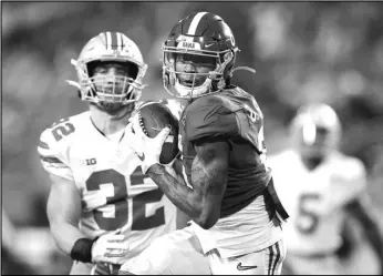  ?? ( Kevin C. Cox/ Getty Images/ TNS) ?? DeVonta Smith # 6 of the Alabama Crimson Tide runs for a 42-yard touchdown during the second quarter of the College Football Playoff National Championsh­ip game against the Ohio State Buckeyes at Hard Rock Stadium on Jan. 11, 2021 in Miami Gardens, Florida.