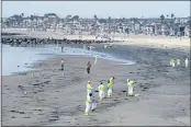  ?? RINGO H.W. CHIU — THE ASSOCIATED PRESS ?? Workers in protective suits clean the contaminat­ed beach after an oil spill, Wednesday in Newport Beach A major oil spill off the coast of Southern California fouled popular beaches and killed wildlife while crews scrambled Sunday, to contain the crude before it spread further into protected wetlands.