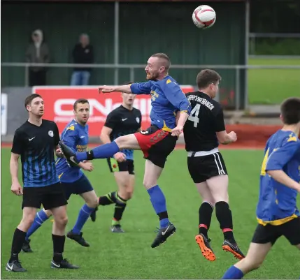  ??  ?? Tomas O’Connor, CS Clochainn Breanainn (black kit), and Ronan Sayers, Mainebank, in action in the Division 2B League Final at Mounthawk Park Photo by Domnick Walsh