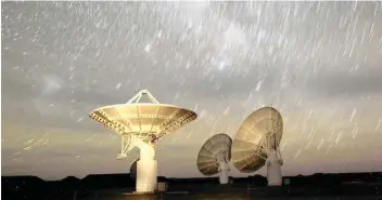  ?? MIKE HUTCHINGS Reuters ?? STAR trails form over radio telescope dishes of the KAT-7 Array in a long exposure picture taken at the proposed South African site for the Square Kilometre Array (SKA) telescope near Carnavon, in the remote Northern Cape province. |