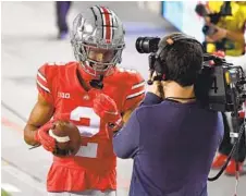  ?? JAMIE SABAU GETTY IMAGES ?? Ohio State receiver Chris Olave, a star at Mission Hills High, smiles for the camera after a touchdown catch against Rutgers on Nov. 7.