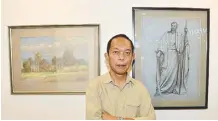  ??  ?? Gabriel Abellana, nephew of Cebuano master artist Martino Abellana, beside Martino’s “Cagayan” and “Santiago” paintings. Abellana is considered the greatest of the portrait painters among the third generation of Cebu’s old masters in painting and sculpture.
