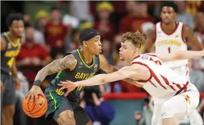  ?? AP Photo/Matthew Putney ?? Iowa State forward Aljaz Kunc (5) works to steal the ball from Baylor guard James Akinjo (11) Saturday during the first half of an NCAA college basketball game in Ames.