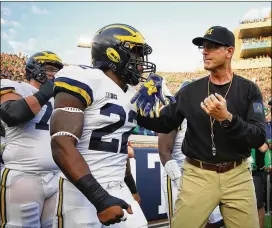  ?? GREGORY SHAMUS / GETTY IMAGES ?? Michigan coach Jim Harbaugh will likely advance to his first College Football Playoff if the Wolverines win out, including the Big Ten title game.