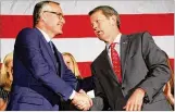  ?? JENNA EASON / JENNA.EASON@COXINC.COM ?? Lt. Gov. Casey Cagle shakes hands with Republican nominee for governor Brian Kemp on Thursday at a party unity rally.