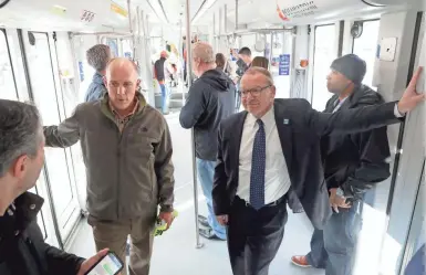  ?? MIKE DE SISTI / MILWAUKEE JOURNAL SENTINEL ?? Milwaukee city engineer Jeff Polenske (left) and Department of City Developmen­t Commission­er Rocky Marcoux ride on the streetcar during a preview Monday.