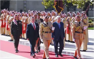  ?? (Muhammad Hamed/Reuters) ?? JORDAN’S KING ABDULLAH and PA President Mahmoud Abbas review a Beduin honor guard at the Royal Palace in Amman yesterday.