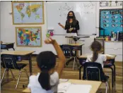  ?? RANDY VAZQUEZ — BAY AREA NEWS GROUP ?? Second and third grade teacher Kylie Shannon, center, answers questions from students during the first day of school at Sunnyvale Christian School in Sunnyvale.