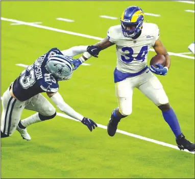  ?? (AP/Ashley Landis) ?? Malcolm Brown (right) of the Los Angeles Rams runs around Dallas Cowboys safety Darian Thompson to score the go-ahead touchdown during the third quarter Sunday in Inglewood, Calif. It was the second touchdown of the night for Brown, who had 18 carries for 79 yards.