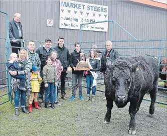  ??  ?? The Grand Champion Steer at the 2018 Norwood Fair was raised by Doug Leahy (pictured in the centre with his family). The animal was purchased by Hilts Butcher Shop (Randy Hilts with his family on the left). Presenting the trophy is fair ambassador Abbi Begg with Steer Judge Dave Denure, with auctioneer Mark Stanley.