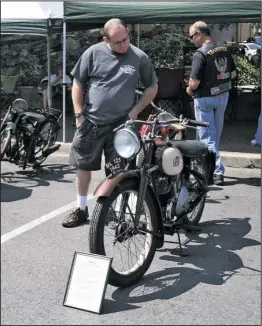  ?? The Sentinel-Record/Mara Kuhn ?? OLD TIMER: Rodney Manning, of Hot Springs, looks at a 1943 Famous James antique motorcycle during the 10th Annual Antique Motorcycle­s in the Park on Saturday at Hill Wheatley Plaza.