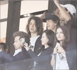  ?? The Asscoatied Press ?? Singer Mick Jagger of the Rolling Stones, in black baseball hat, smiles during the semifinal match between Croatia and England at the 2018 soccer World Cup in the Luzhniki Stadium in, Moscow, Russia, on Wednesday.