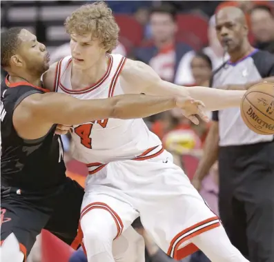  ?? ERIC CHRISTIAN SMITH/ AP ?? Bulls forward Lauri Markkanen, dribbling against Rockets guard Eric Gordon, scored a team- high 22 points Tuesday.