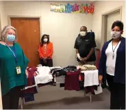  ?? (Special to The Commercial) ?? Evelyn Harrison (from left), Betty Sneed, Gregory Moore and FayLisa Suggs accept donations at 34th Avenue Elementary School.