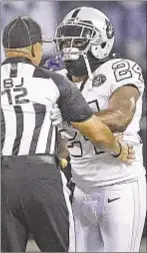  ??  ?? Marshawn Lynch pushes ref Thursday night and is ejected during Raiders’ win over Chiefs.