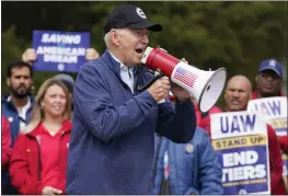  ?? EVAN VUCCI — THE ASSOCIATED PRESS ?? President Joe Biden joins striking United Auto Workers on the picket line Tuesday in Van Buren Township, Mich.